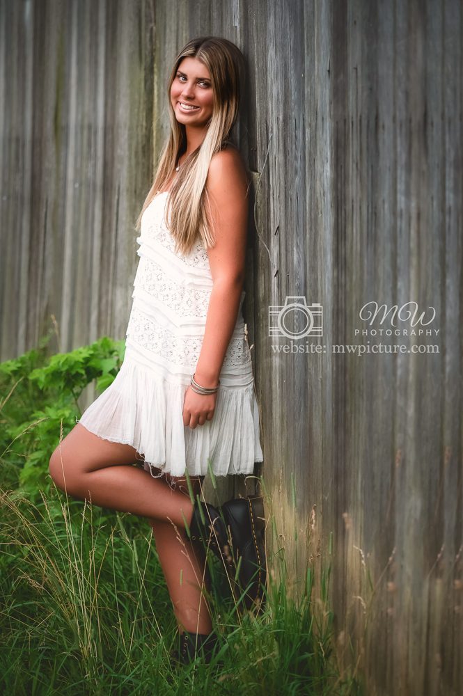 A Young Woman Standing Near Wooden fence