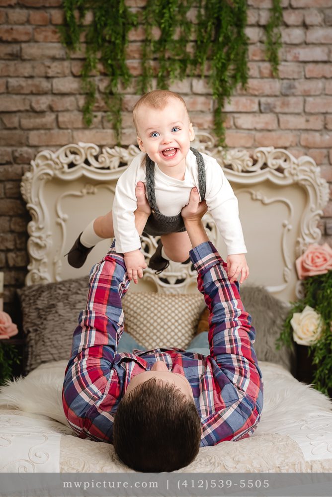 A Child Playing with Father on His First Birthday