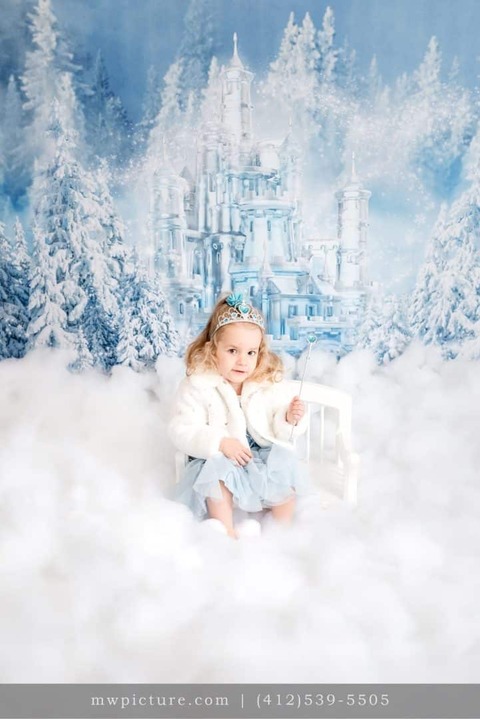 A Little Girl Sitting with Chair and Ice Castle in the Back