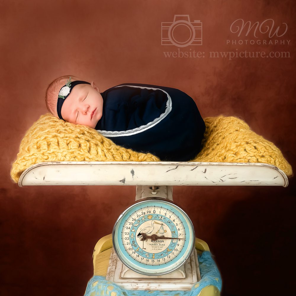 A baby is laying on top of a scale