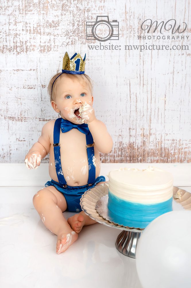 A baby wearing a blue diaper and bow tie