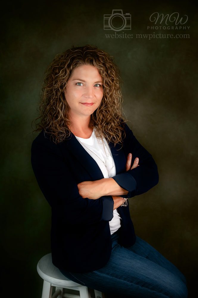 A woman with curly hair posing for the camera.