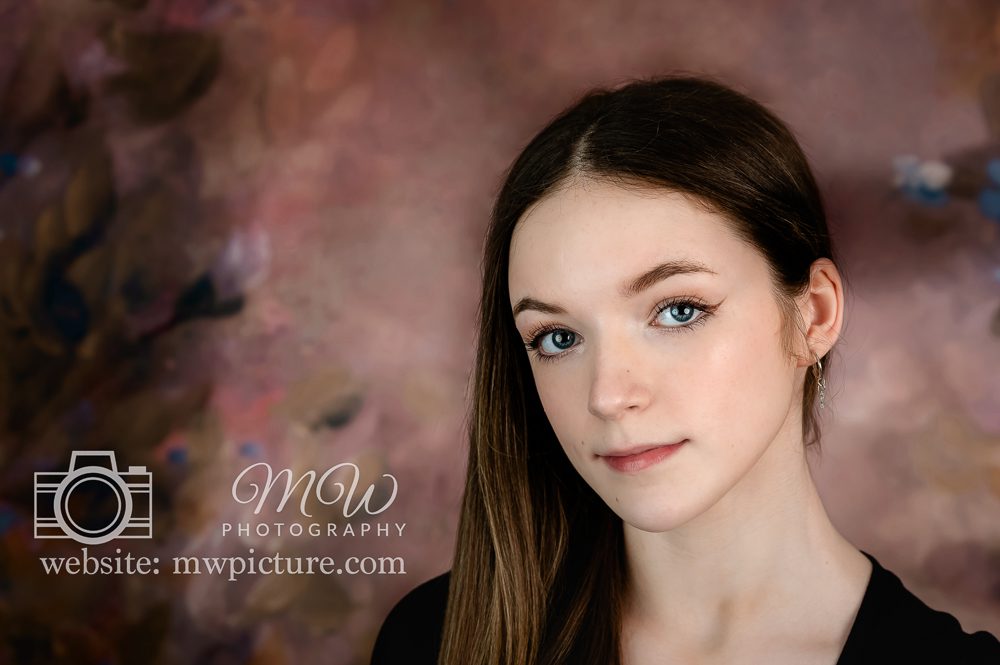 A young girl with long hair and blue eyes.