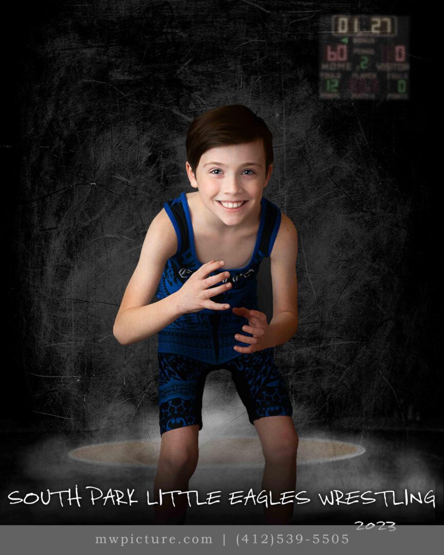 A young boy posing for a picture in front of a black background.